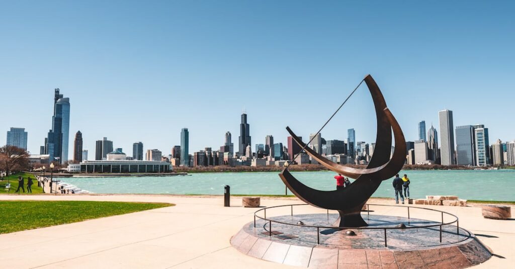 a scenic view of chicago skyline from the waterfront with modern architecture and a striking sculptu